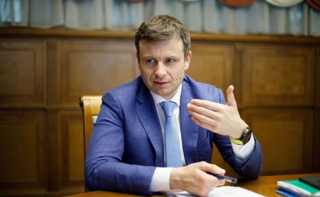 Министр финансов Украины Сергей Марченко на фоне новостной сводки